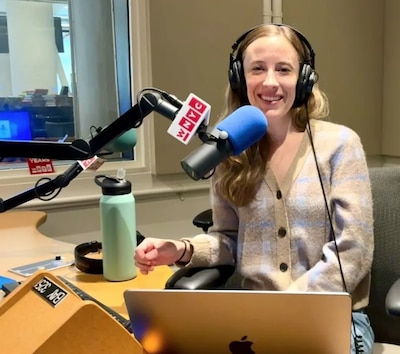 Marisa Donnelly sits in front of the microphone in a radio studio.