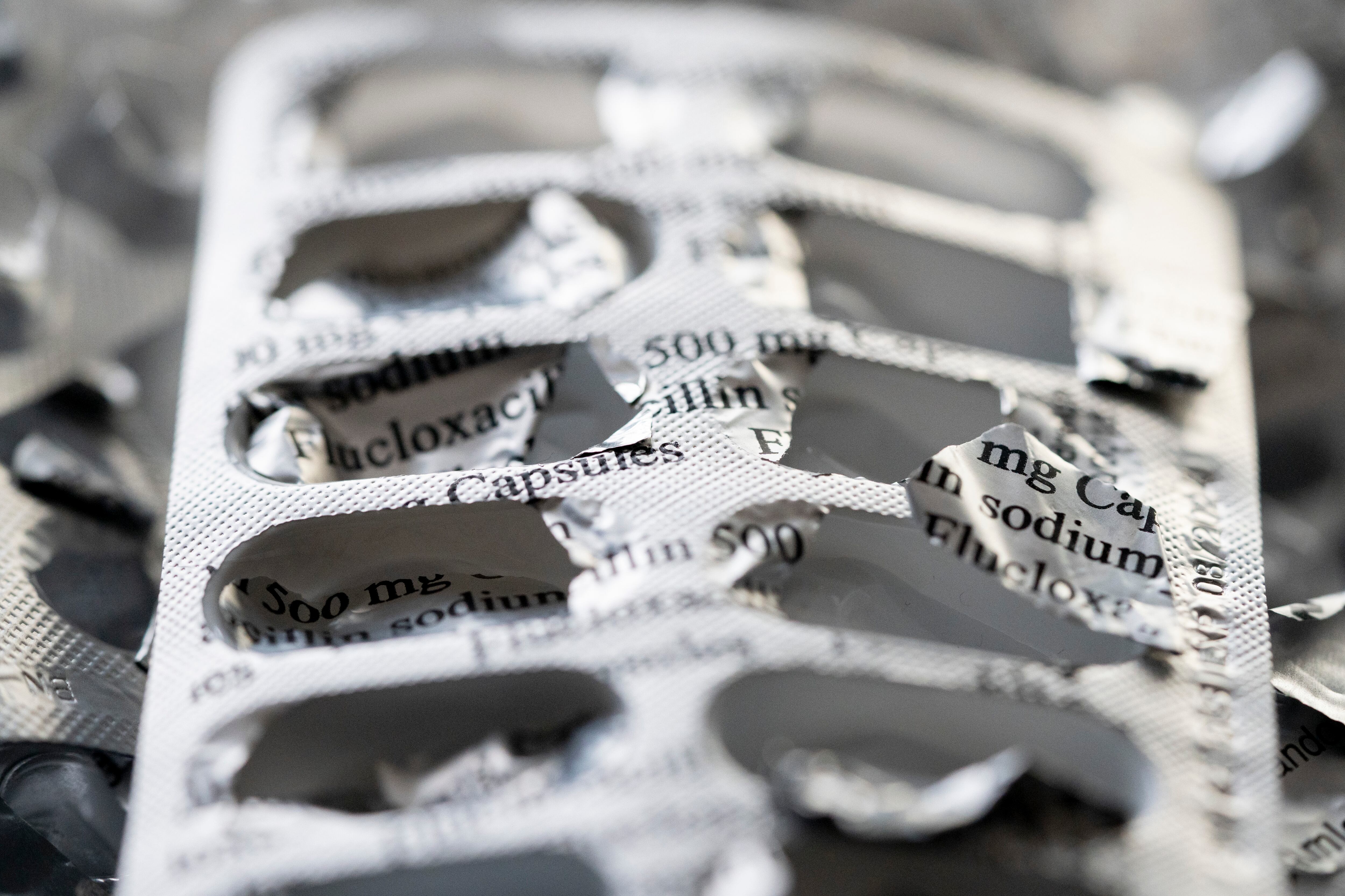 An open foil pack of antibiotic pills.