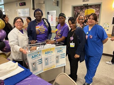 A group of medical professionals stand together and pose for a photograph.