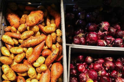 Boxes of potatoes and onions at a warehouse.