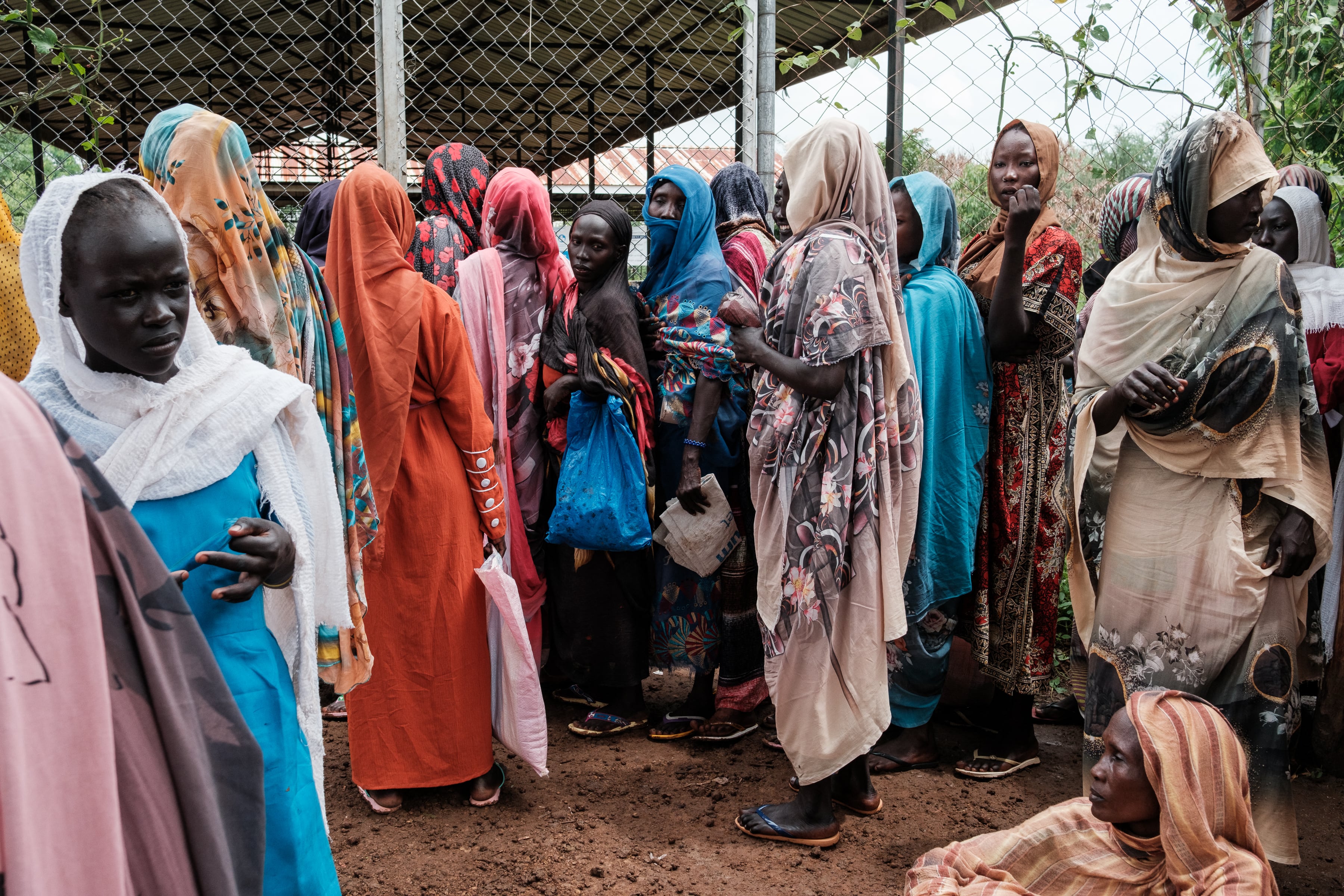 Women line up to collect food and cash in South Sudan.