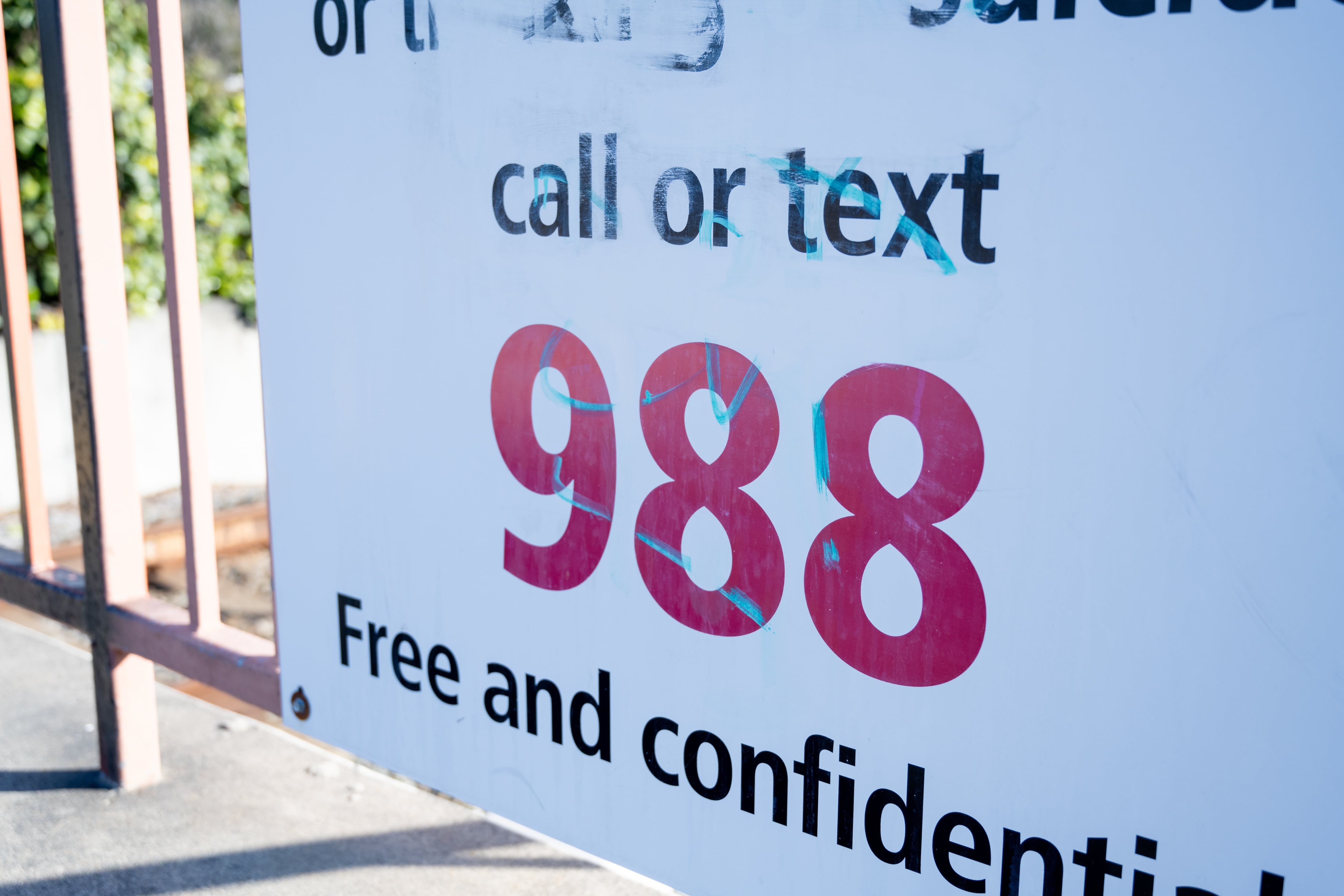 A sign for the 988 crisis line.