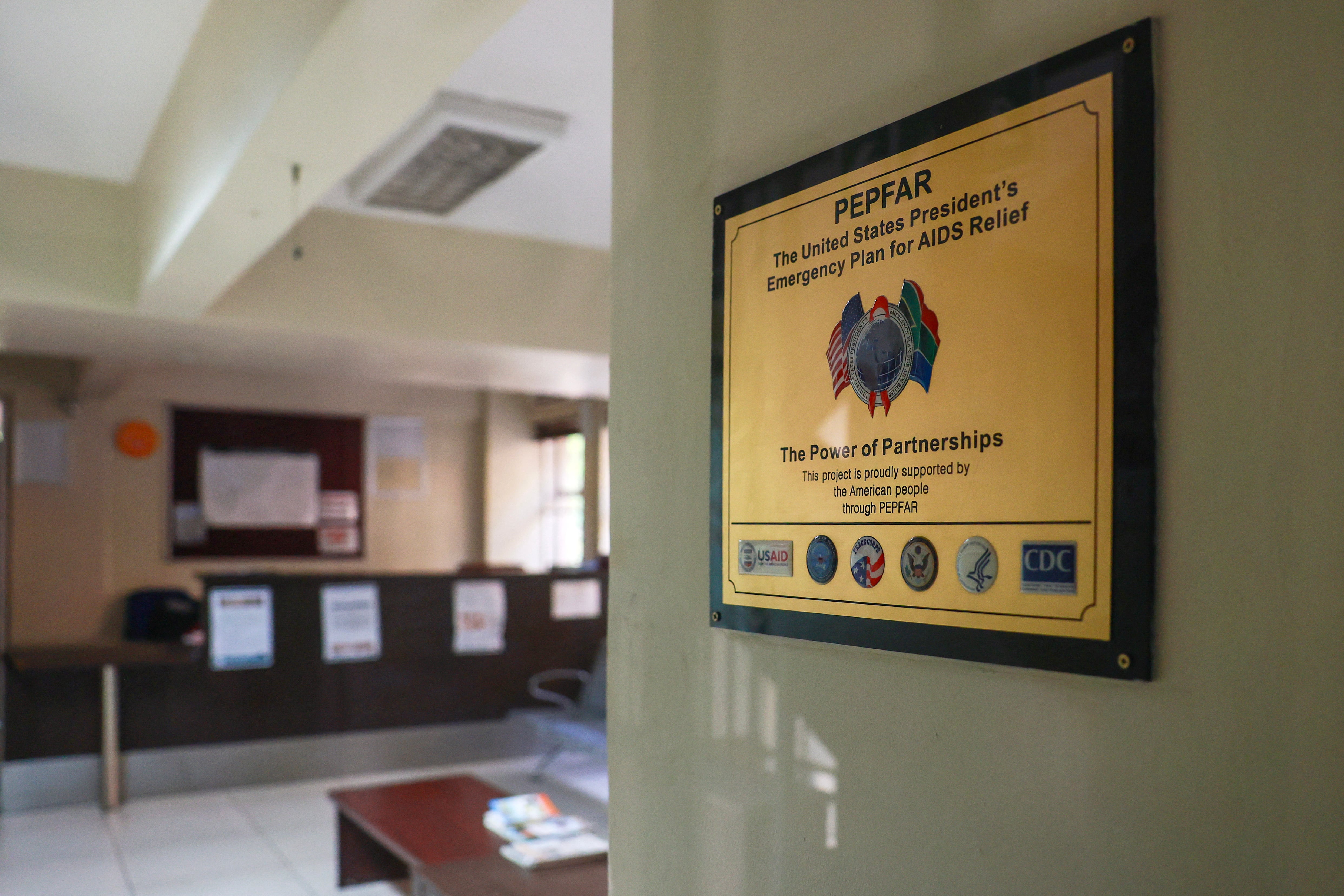 A PEPFAR sign hangs in a health facility.
