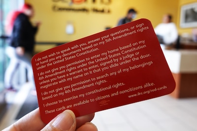 A red card outlines sample statements for people interacting with federal immigration agents.
